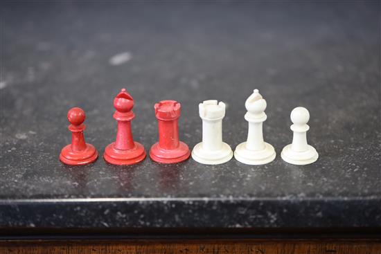 A 19th century bone chess set (two red pawns differ)